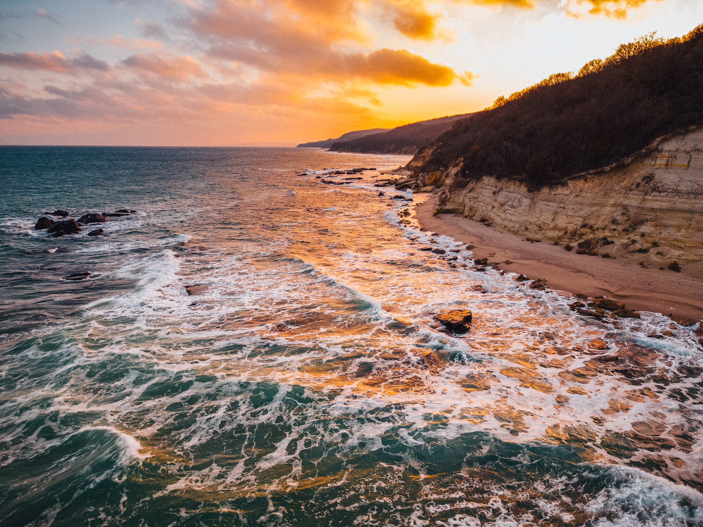 Australian coastline at golden hour, reflecting the wild landscape that inspired the story behind Myrlèmon Australian vodka liqueur.