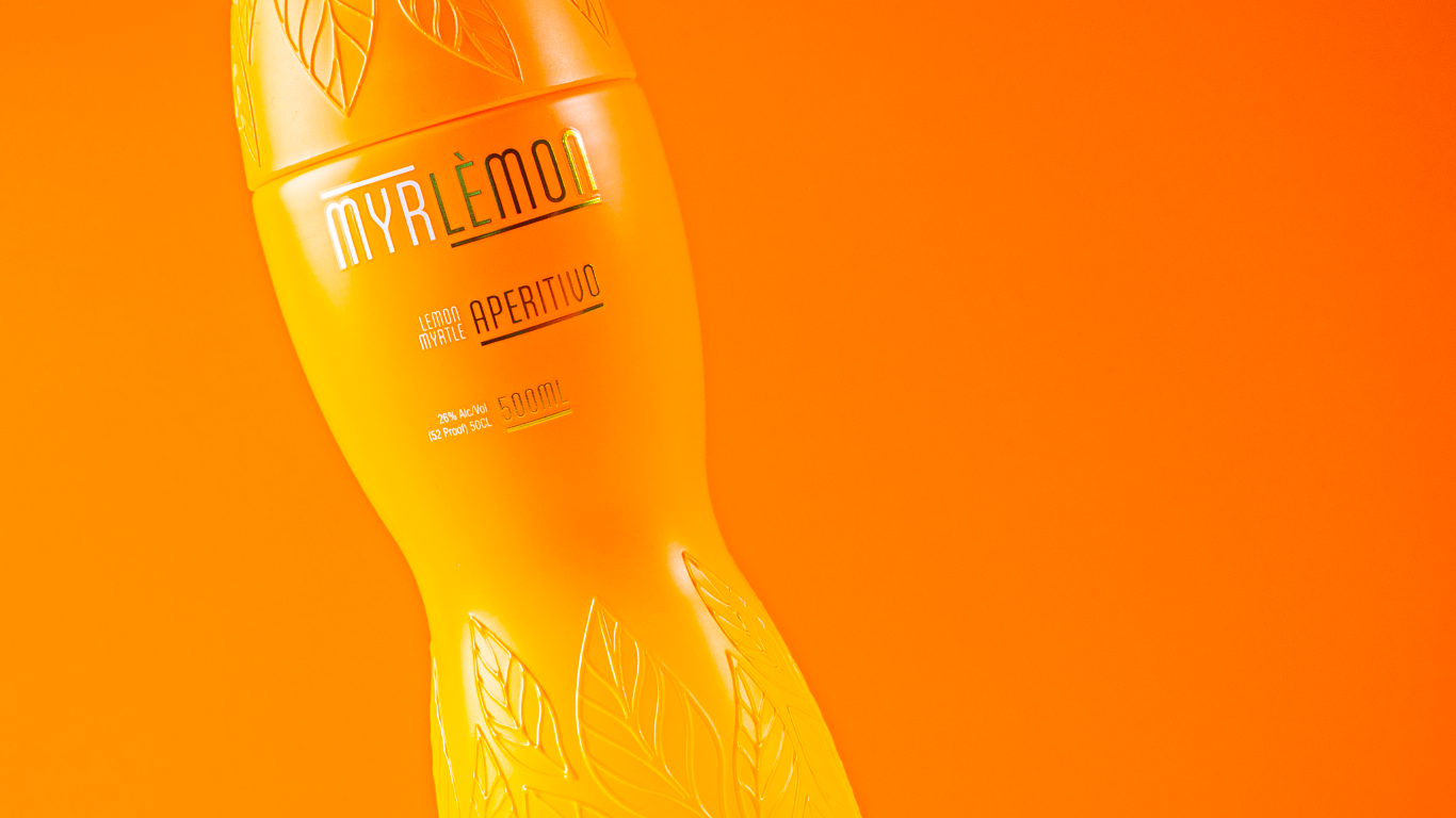 Yellow bottle labeled 'MyrLemon' on an orange background
